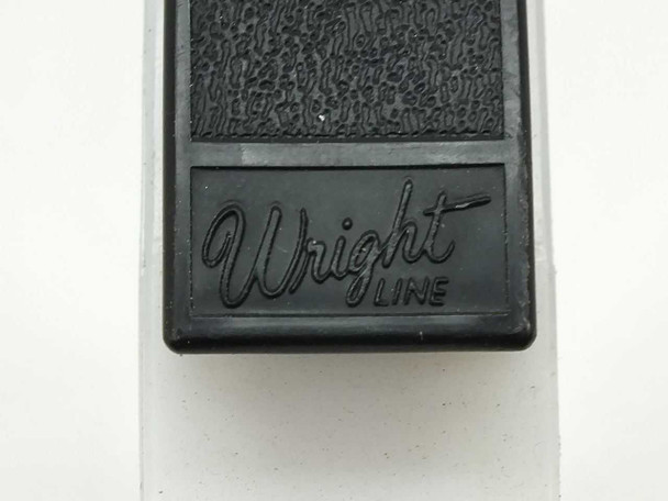 Wright Line brand embossed canister latch/clip – close-up showing Wright Line logo on black plastic tape canister latch