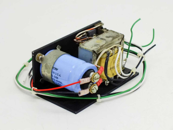 Standard Power 15B24H 24V power supply – angled top view showing large blue capacitor, transformer, and color-coded wire leads on black mounting plate
