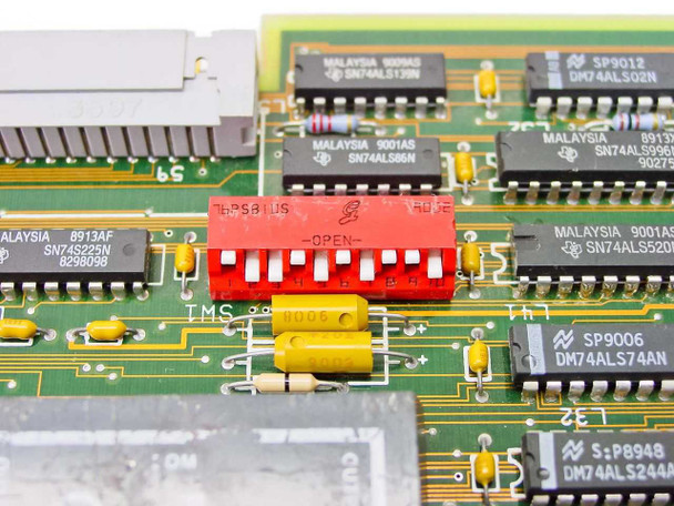 Wang 8987-0 close-up of red DIP switch bank (TMS, labeled OPEN) with surrounding TI SN74ALS series logic ICs