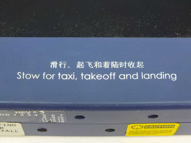 Bottom edge of 40-624715-101 aircraft seat testing monitor showing Chinese and English stow instruction text and revision markings