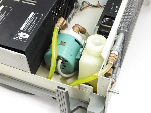 Nicolet Spectrometer Service Module – interior close-up of teal coolant circulation pump, copper fittings, yellow-green tubing, coolant reservoir, and power supply block