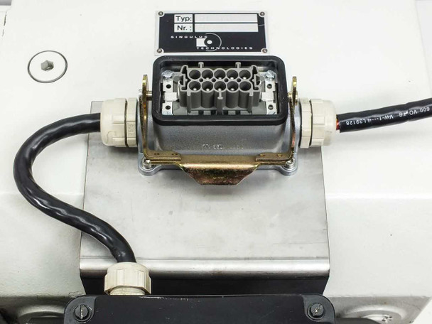 HC0110S module top view showing multi-pin industrial connector housing with cable entry glands and Singulus Technologies label