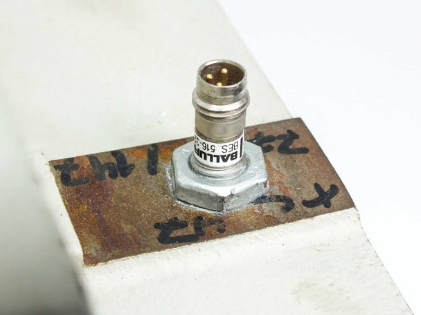 Balluff BES 516 proximity sensor mounted on TC47 servo module housing — close-up view with surface corrosion visible