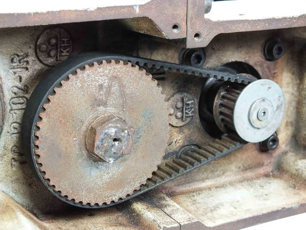 Singulus TC 47 – close-up of large drive sprocket and HTD timing belt showing surface oxidation and gear tooth detail