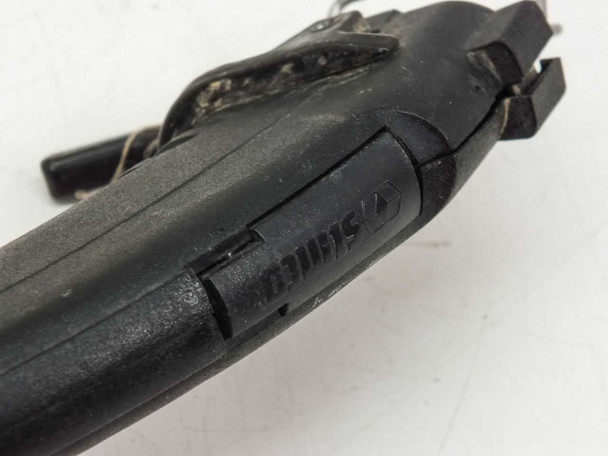 Simco F10 Top Gun handheld gun top view — Simco molded branding on gun body, visible scuffs and wear on black housing