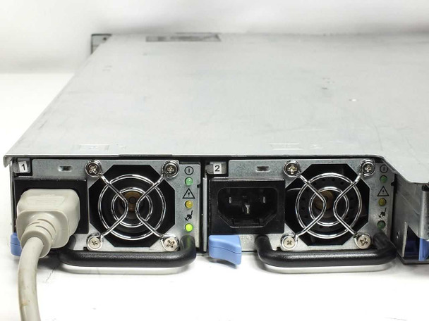 Dell PowerEdge 1850 rear PSU bay close-up – PSU 1 with IEC power inlet and green status LEDs, power cord connected