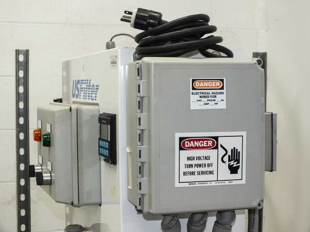 Electrical enclosure panel mounted to wall bracket with Danger High Voltage warning labels and power cord; GF Signet pH/ORP controller visible to left