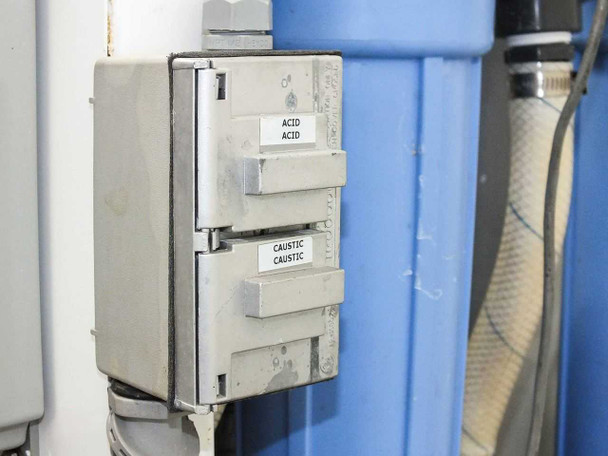 Chemical dosing relay box with Acid/Acid and Caustic/Caustic labeled channels mounted to side of system