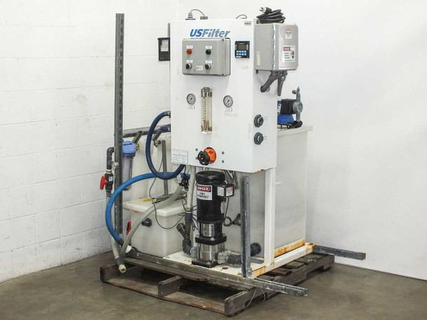 USFilter 67/S4201-300 Rinse Recirc Aquasaver water monitor system — full front view showing control panel, Baldor pump motor, tanks, and plumbing on pallet
