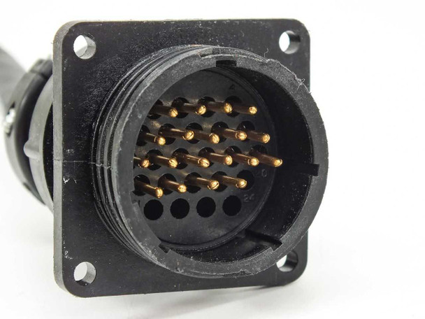 Close-up of multi-pin round trunk connector on Phoenix Contact SACB-8/16 showing gold male pin array and panel-mount flange