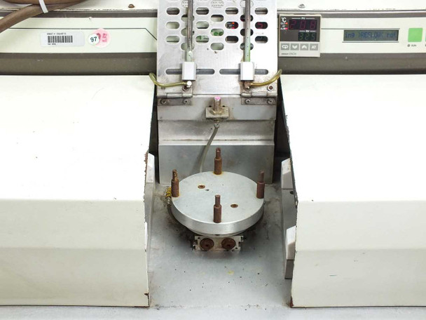 Center work area showing circular pneumatic platen with mounting studs between the two heated zones