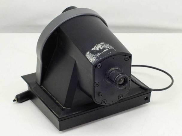 Polaroid MicroCam – rear view showing black housing with white adhesive residue/label damage on back panel and the eyepiece lens port on the right side