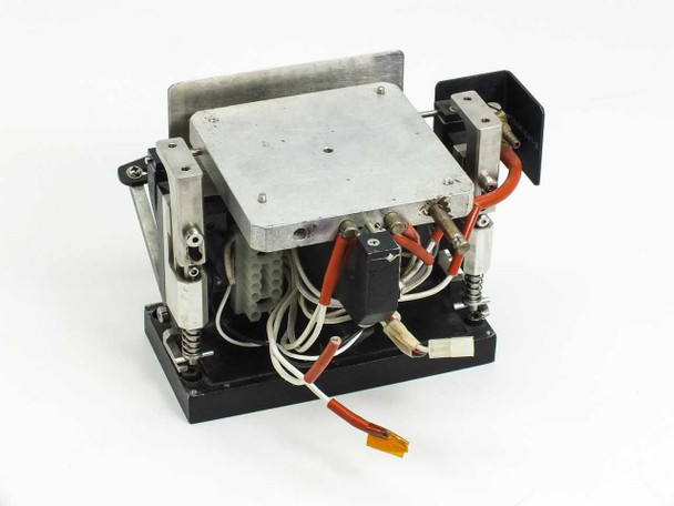Steag Firstlight heating element — rear-left view showing orange high-temperature wiring, white multi-pin connector, and spring-loaded lifting mechanism