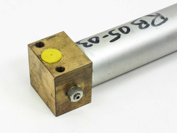 Close-up of rear brass end cap showing yellow port plug, two mounting holes, and handwritten barrel marking RB05-03