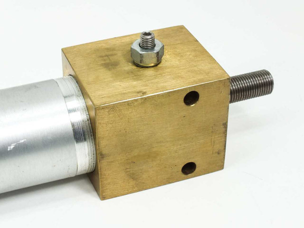 Close-up of rod-end brass end cap top view showing mounting holes, threaded rod, and hex nut