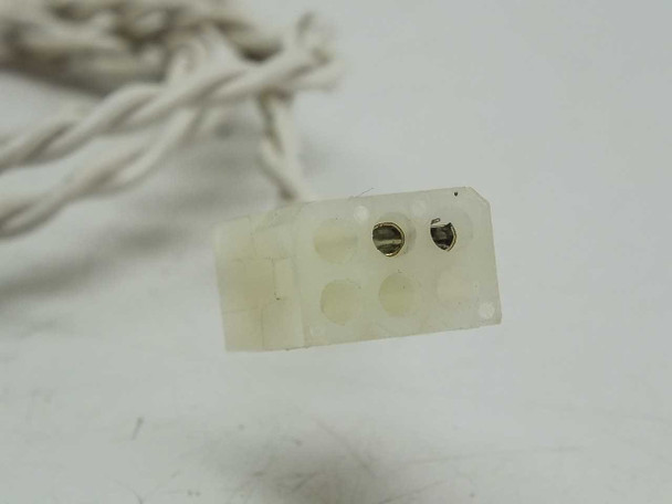 Close-up of 2-pin Molex-style connector on twisted white lead wires