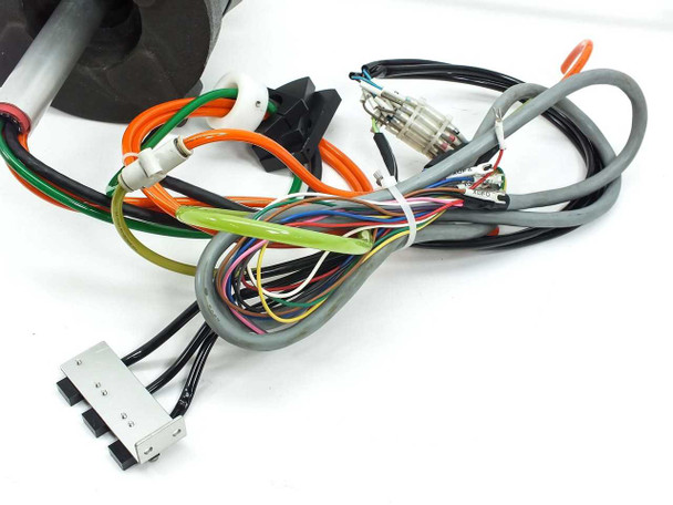 Wiring harness closeup showing multi-conductor cables, orange, green, gray, and black wires with terminal connectors