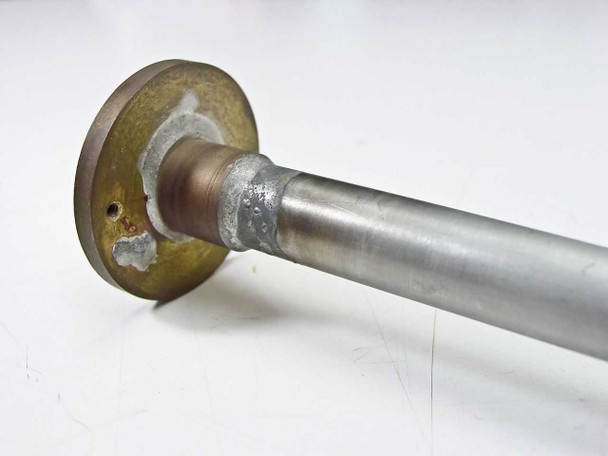 Stainless steel feedthrough tube – side view of flanged end showing solder/weld joint at flange-to-tube interface with surface oxidation