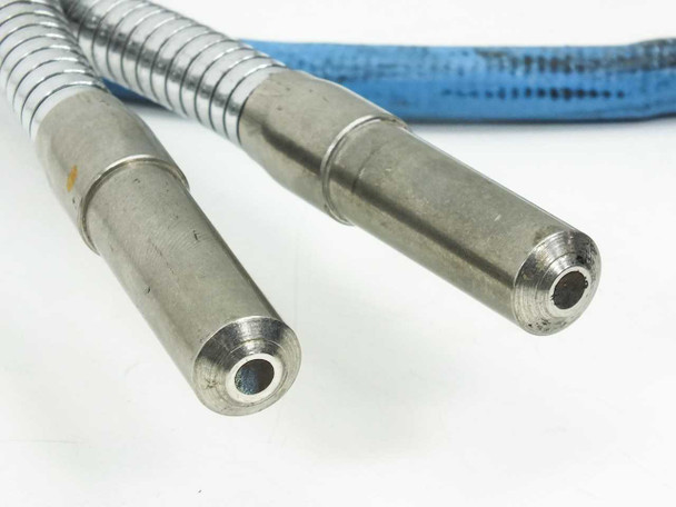 Close-up of the two dual-arm output tip connectors side by side — stainless steel cylindrical ferrules with hollow fiber bundle openings visible at the end faces