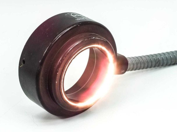 Volpi fiber optic ring light cable — ring mount illuminated and glowing orange, demonstrating fiber optic light transmission through the ring