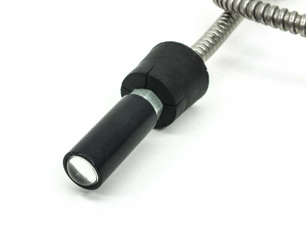 Close-up of the black rubber input light tip showing the fiber optic face and chrome flex cable connection — 15mm diameter cylindrical tip