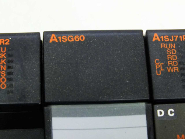 Mitsubishi MELSEC A1SG60 blank/dummy module installed in base unit slot – close-up view