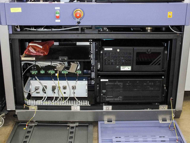 Camtek Falcon PD – electronics rack inside main cabinet showing rackmount computers, power distribution, E-stop buttons, and wiring harness
