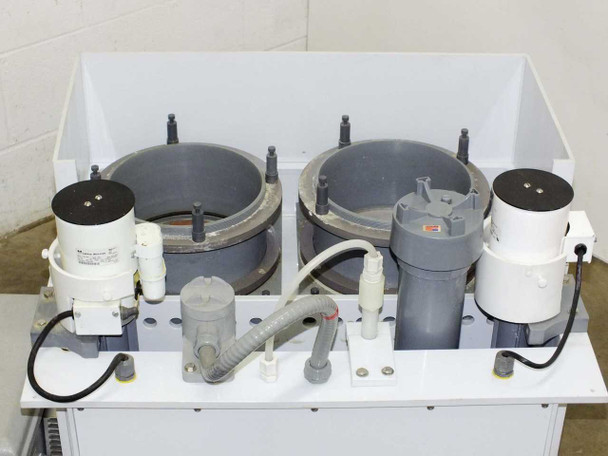 Top view of HDPE mixing station showing dual pump assemblies, PVC piping, and tank openings