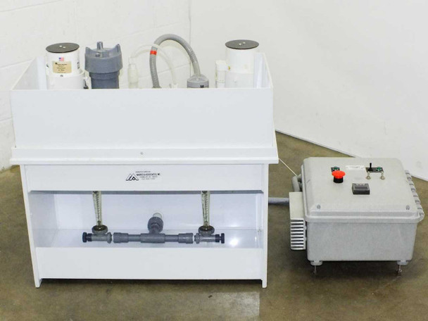 Full side view of HDPE mixing station body with process piping, centrifugal pumps, and separate control box