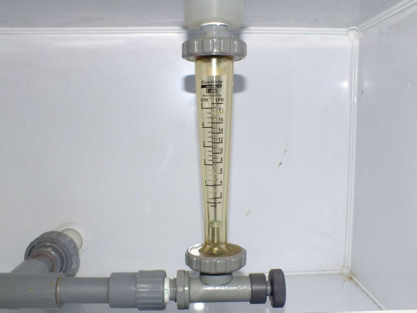 Blue-White Industries F-450 flow meter installed in mixing station plumbing, full view with PVC fittings and needle valve