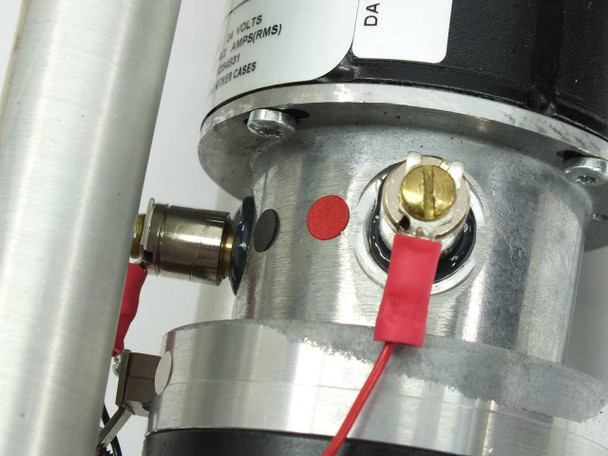 Pacific Scientific 3N63-030-6 motor brush access area – close-up showing two brush access ports, red brush lead wires, and gold-slotted brush retainer cap