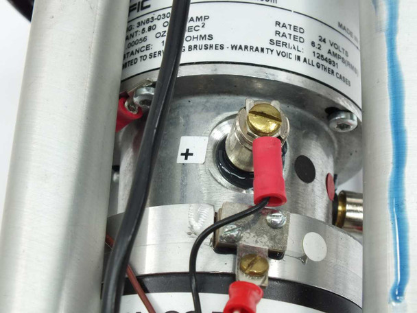 Pacific Scientific 3N63-030-6 motor – close-up of positive terminal connection showing red lead wire, gold terminal post, rating plate, and partial brush assembly area