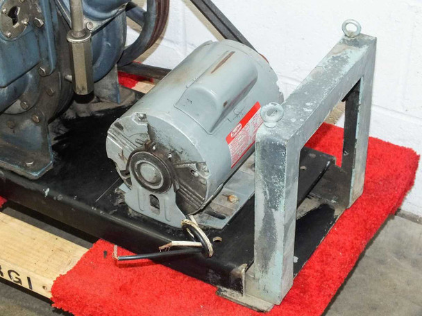 Dayton 4K789F 3/4 HP motor mounted on steel frame — front/drive-end view with belt and Allen wrench