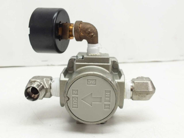 SMC AR30-N03-Z regulator bottom view showing IN and OUT port markings and NPT fittings