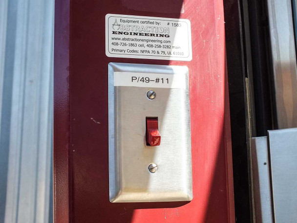 Abstraction Engineering fume hood certification label and red toggle power switch with P/49-#11 designation on dark red side panel