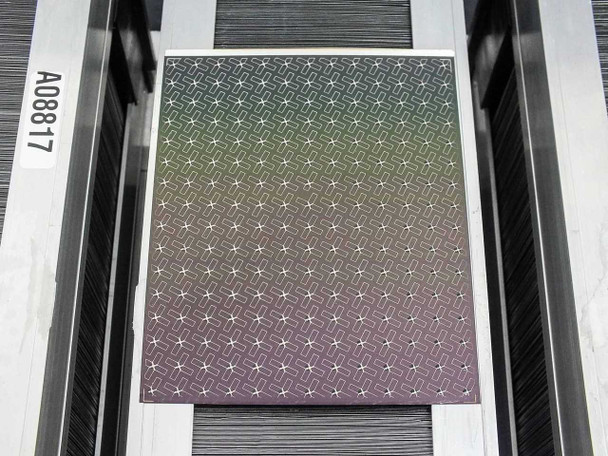 Single Nanosolar NanoCell CIGS cell removed from tray, showing MWT star/cross screen-printed grid pattern on active surface, tray label A08817 visible