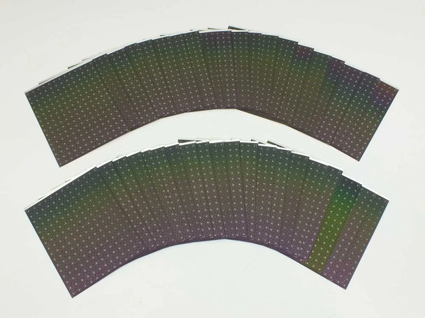 Fan of Nanosolar NanoCell flexible CIGS solar cells showing iridescent thin-film surface with MWT screen-printed grid pattern