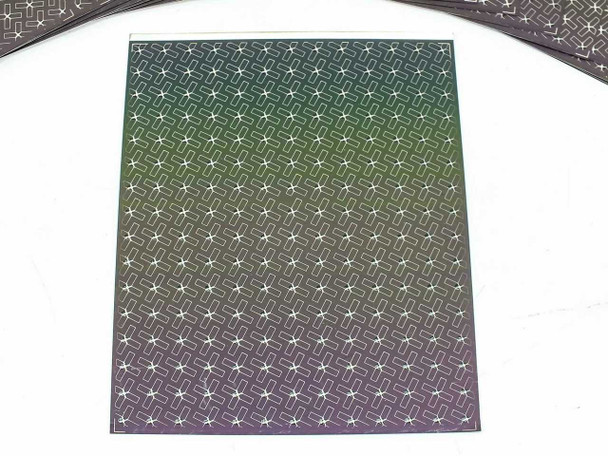 Single Nanosolar NanoCell CIGS solar cell showing iridescent active surface with MWT contact grid pattern under studio lighting