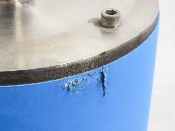 Electro-Coatings nip roller – close-up of rubber edge near bottom flange showing cracking and chipping of blue EPDM surface at roller end
