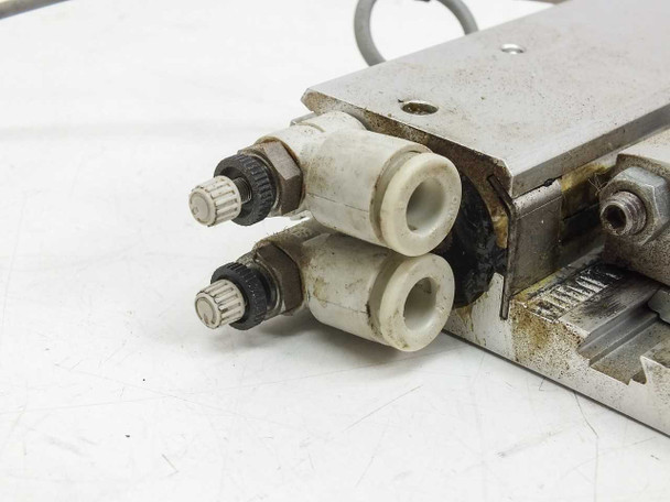 Festo SLG-18-500-YSR-A — close-up of drive end showing four push-in pneumatic port fittings with grime/wear and sensor cable connector