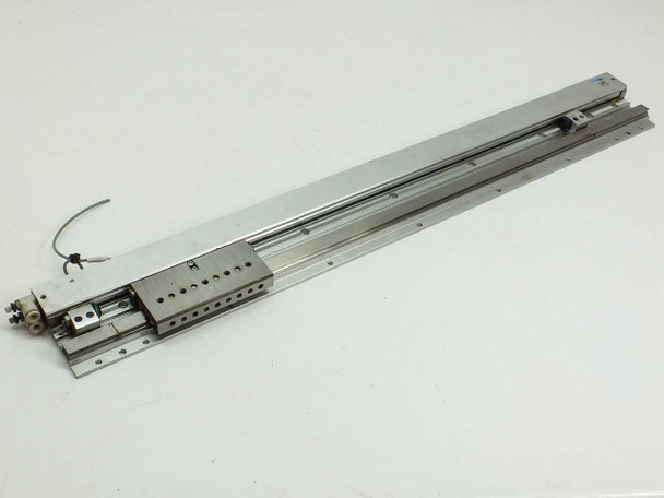 Festo SLG-18-500-YSR-A pneumatic linear slide — full length top-angle view showing aluminum extrusion body, carriage with mounting holes, and trailing sensor cable