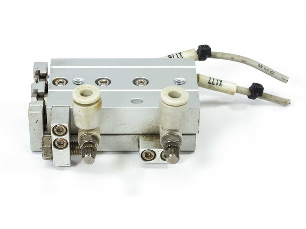 SMC MXS6-20 dual-rod guided slide – rear-angle view showing adjustable end stops, push-in ports, and SMC sensor leads