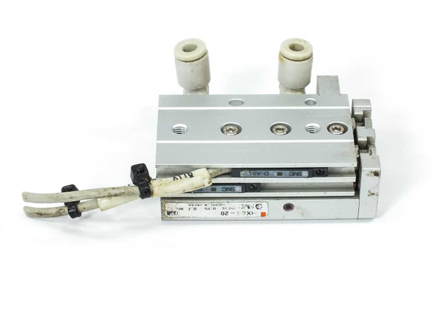 SMC MXS6-20 pneumatic guided slide cylinder – front-angle view showing dual push-in fittings on top and two sensor wires with cut connectors