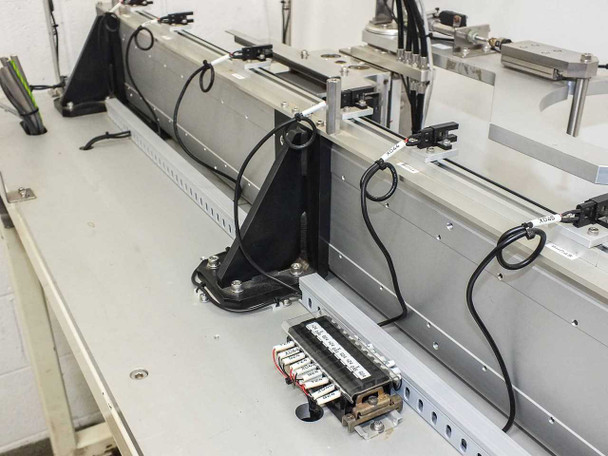 Linear rail and carriage detail — showing aluminum extrusion rail, sensors, and wiring terminal block