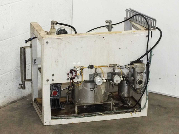 Rear view of lacquer dispensing system showing stainless containers, manifold plumbing, electrical connections, and frame structure
