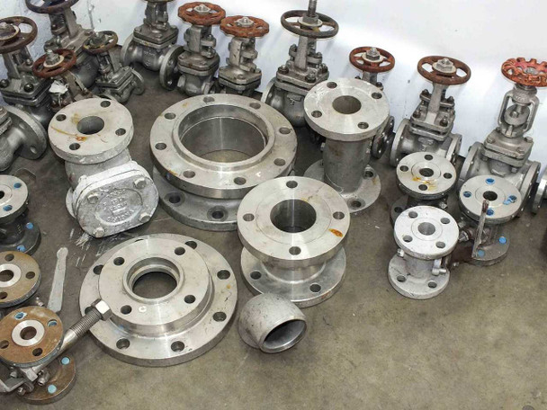 Overhead view of lot showing large stainless steel flange blanks alongside Powell and Aloy Co. gate valves