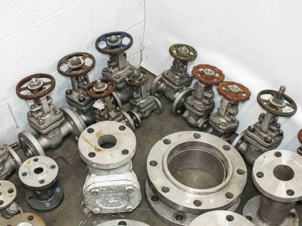 Group of Powell and mixed-brand stainless steel flanged gate valves including large-bore flanges and smaller valves