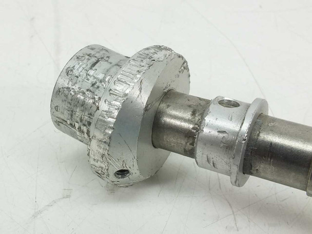 Close-up of heavily worn aluminum microscope focus knob shaft assembly showing significant surface damage and corrosion