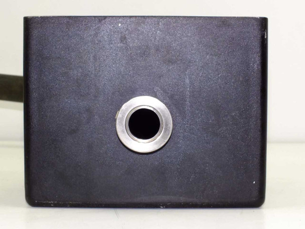 Edwards vibration isolation block — black anodized aluminum body with single circular port opening, front face view