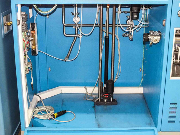 Interior lower cabinet view showing gas manifold plumbing, stainless tubing, fittings, and Funak pump assembly